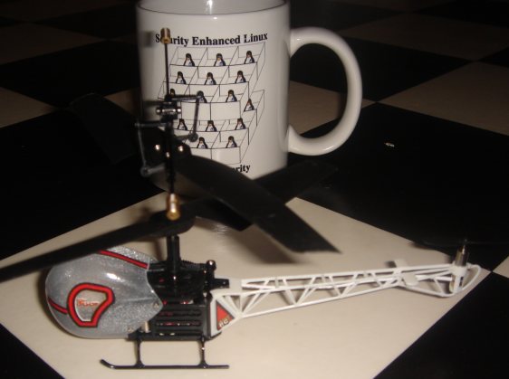 toy helicopter in front of SE Linux mug