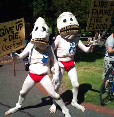 Two people dressed as Gollum with Liberal Party badges advocating that we die tax-free and that the Liberal party is for famine, fire, and flood