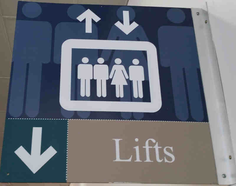 3 men 1 women on lift sign